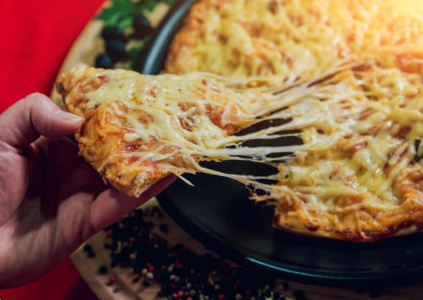 istock A slice of pizza in his hand. A restaurant. 910229310