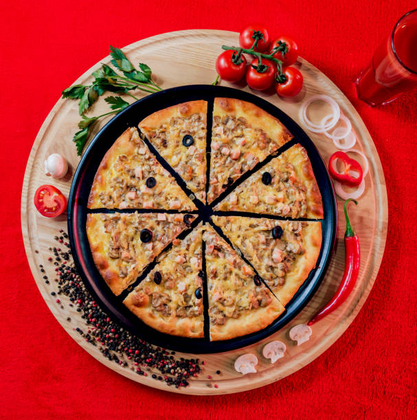 istock Large hot pizza on the black plate. 910232206