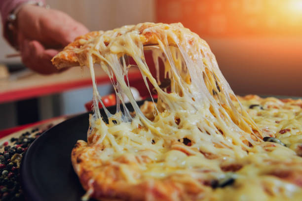istock A slice of pizza in his hand. A restaurant. 910234836