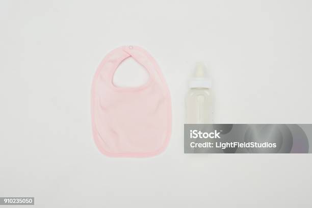 Top View Of Baby Bib And Bottle Of Milk Isolated On White Stock Photo - Download Image Now