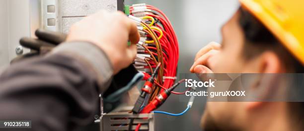 Electrician Engineer Tests Electrical Installations On Relay Protection System Stock Photo - Download Image Now