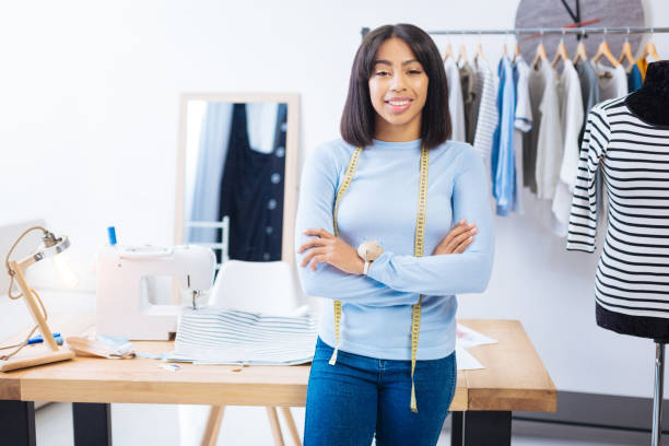istock Skilled young worker standing with her arms crossed and smiling 910238254