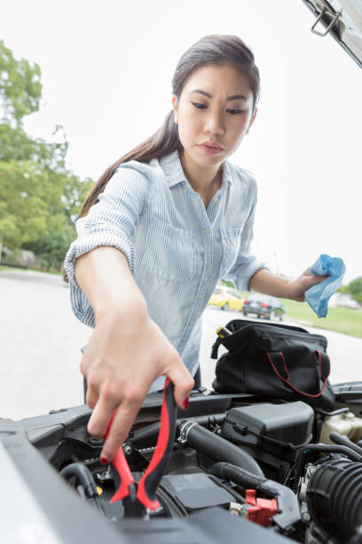 istock Woman jumps car battery 910238384