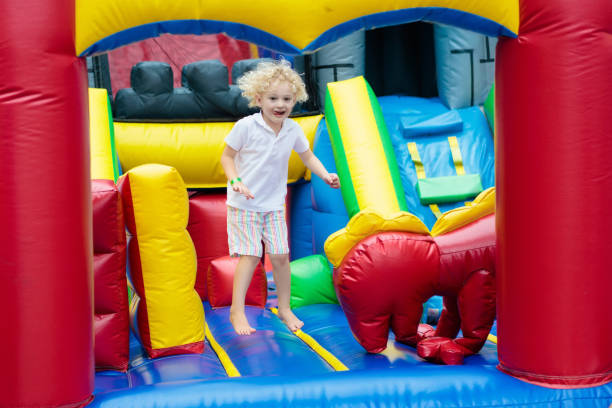 istock Child jumping on playground trampoline. Kids jump. 910241438
