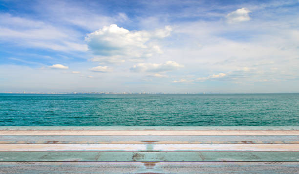 istock Wood table top with nature scene tropical beach and blue sky 910243832
