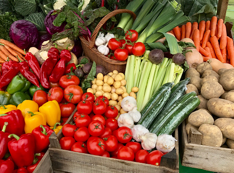 A assortment of fresh vegetables for sale on a market stand.