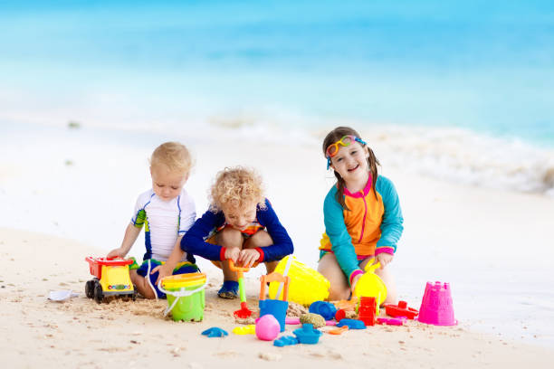 istock Kids on tropical beach. Children playing at sea. 910245762