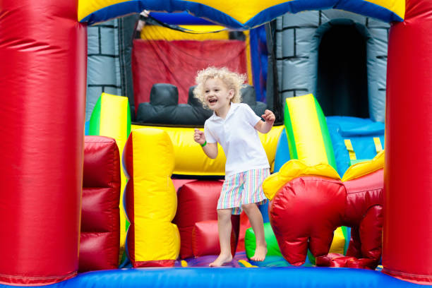 istock Child jumping on playground trampoline. Kids jump. 910246760