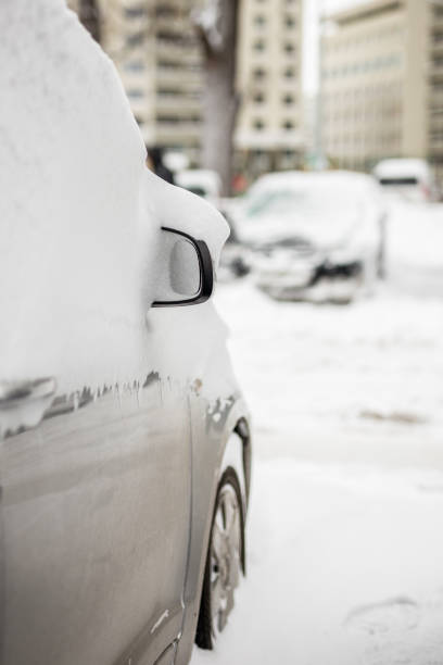 istock Car on a street covered with big snow layer. 910246940
