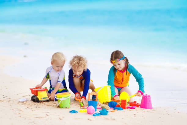 istock Kids on tropical beach. Children playing at sea. 910251504
