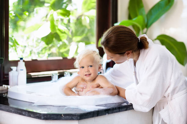 istock Mother washing baby in bubble bath. Water fun. 910251648