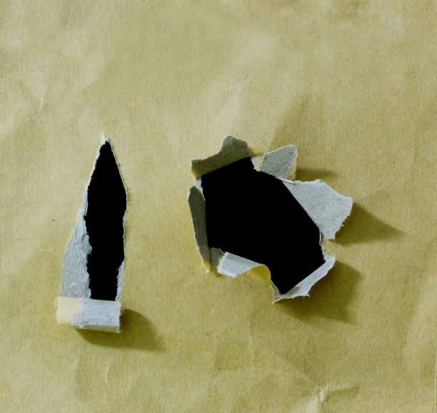 istock pieces of hole torn paper 910253038