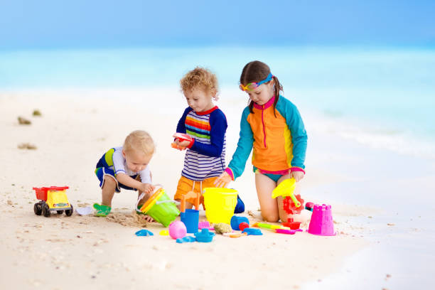 istock Kids on tropical beach. Children playing at sea. 910253218