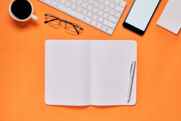 istock Black screen notebook blank and laptop placed orange background. Suitable for graphics used for advertising. 910258630