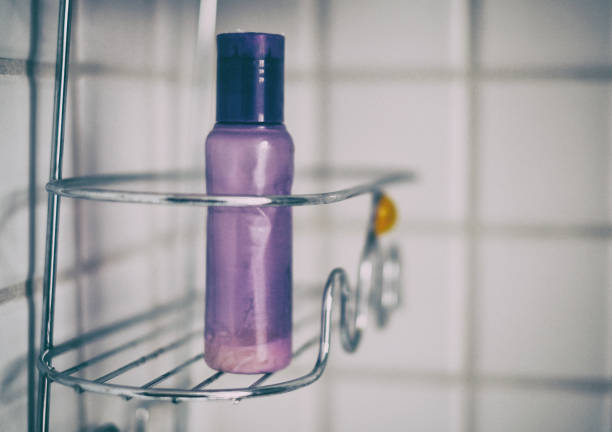Purple bottle in shower caddy stock photo