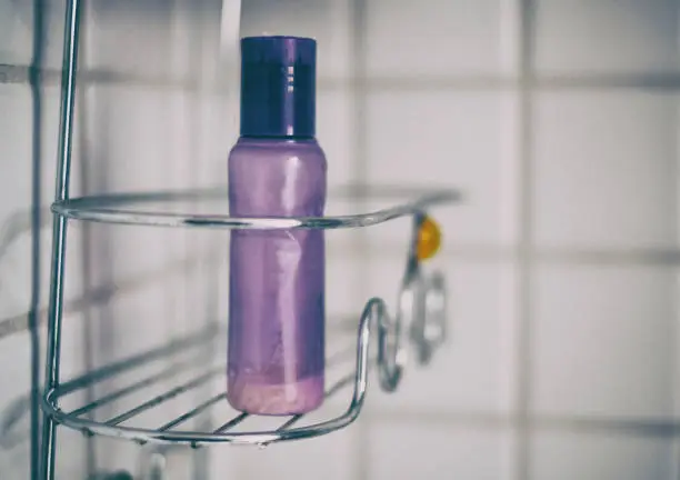 Purple bottle in shower caddy