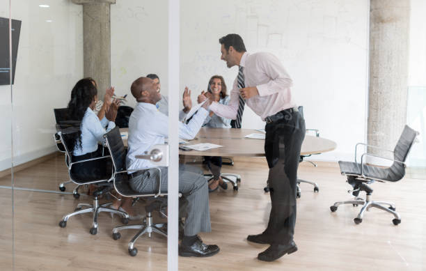 istock Men handshaking and celebrating their success at the office 910261952