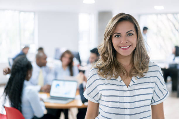 istock Successful business woman leading a group at the office 910261984