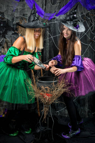 istock beautiful witches with pot for potions posing 910262106
