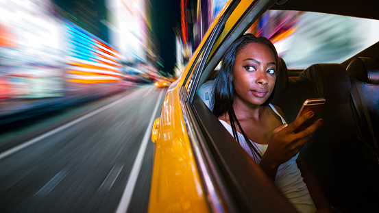 African American Woman Commuting by Taxi in New York City.