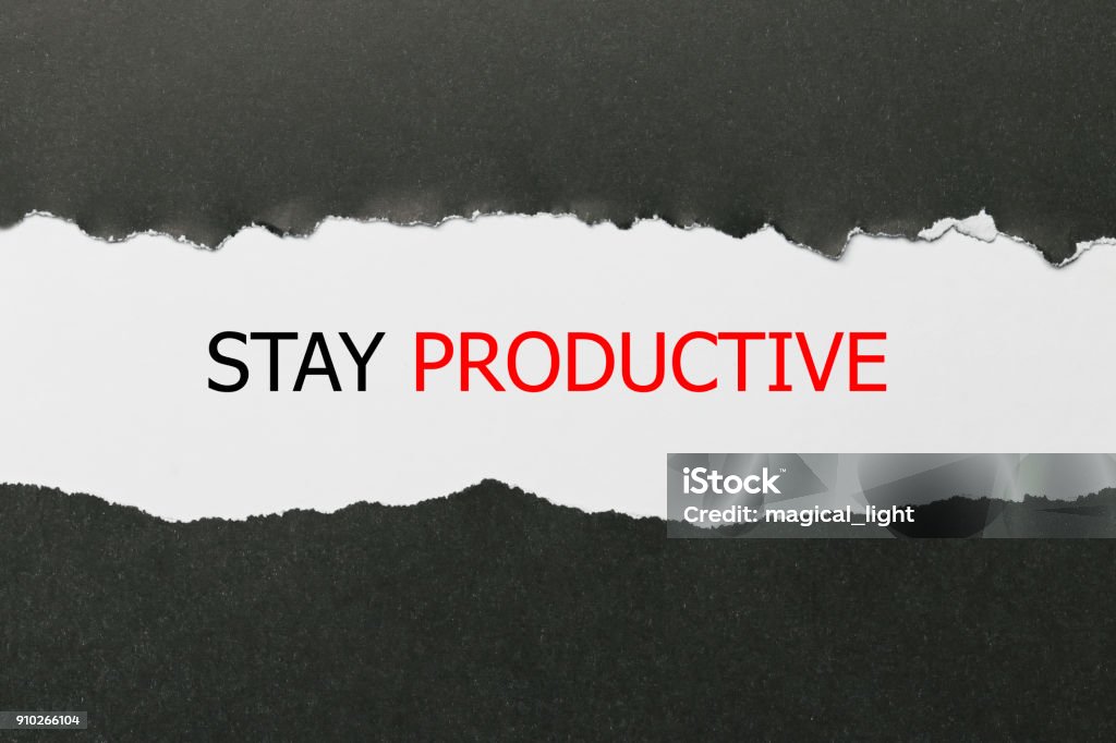 Stay Productive Motivation quote written behind a torn paper Business Stock Photo