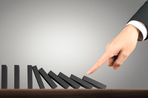 istock Hand Stopping domino concept 910266524