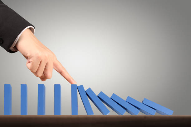 istock Hand Stopping domino concept 910266544