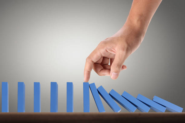 istock Hand Stopping domino concept 910266550