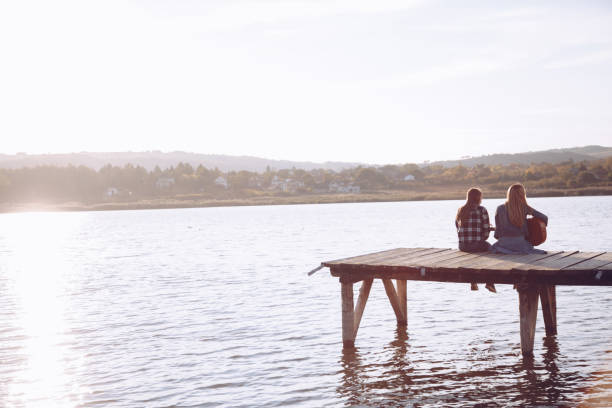 istock Friends playing guitar on pier 910269060