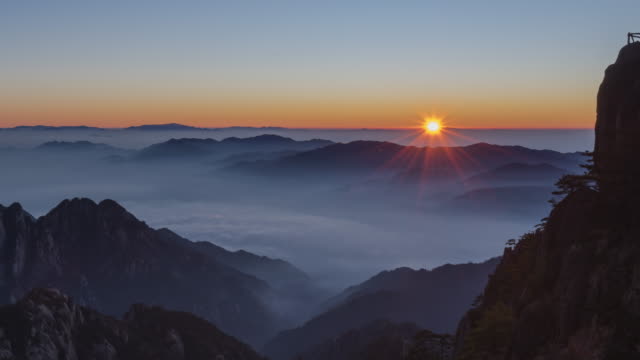 Sunrise from Bright top peak of  Huangshan mountain - time lapse