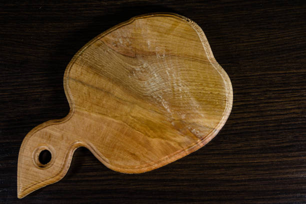 istock Cutting board on the dark wooden table. Top view 910274534