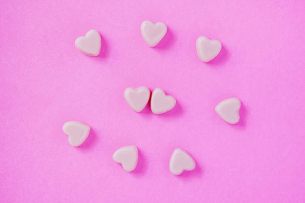istock valentine candy hearts shape on pink background 910274648