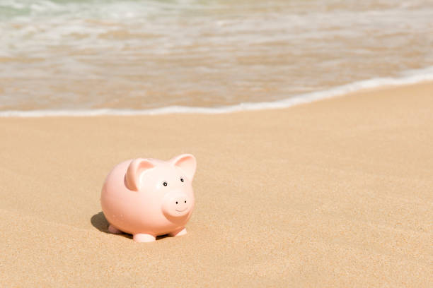 istock Piggy Bank by the Sea Shore with Copy Space 910275848