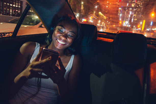 Taxi Ride in New York City African American Woman Commuting by Taxi in New York City. black taxi stock pictures, royalty-free photos & images