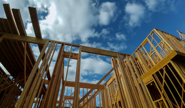 istock New residential construction house framing against a blue sky. 910280856