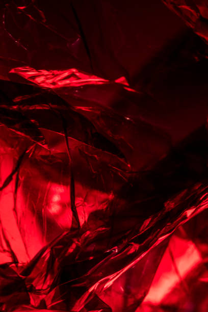 istock Plastic Shiny See Through Abstract Shimmer Creased Background Red 910280948