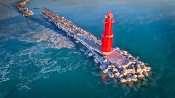 The lighthouse sits on the on the edge of the frozen Lake Michigan in the coldest winter moths on the Great Lakes.