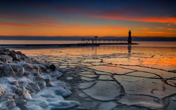 The lighthouse sits on the on the edge of the frozen Lake Michigan in the coldest winter moths on the Great Lakes.