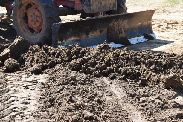 istock tractor push clot soil after pour from truck 910286830