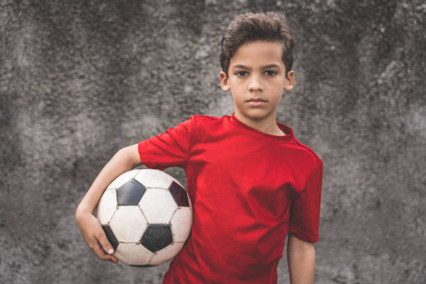istock Skilled boy playing football 910289348