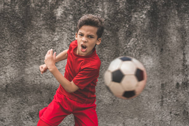 istock Skilled boy playing football 910289444