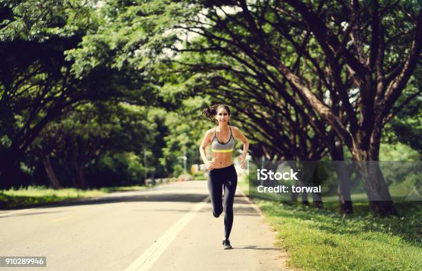 Asian Women Jogging In The Morning At The Park Stock Photo - Download Image Now - Active Lifestyle, Adult, Adults Only
