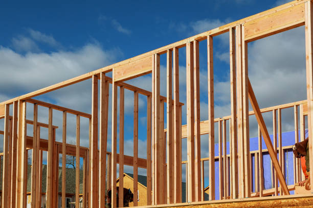 istock New residential construction house framing against a blue sky. 910290422