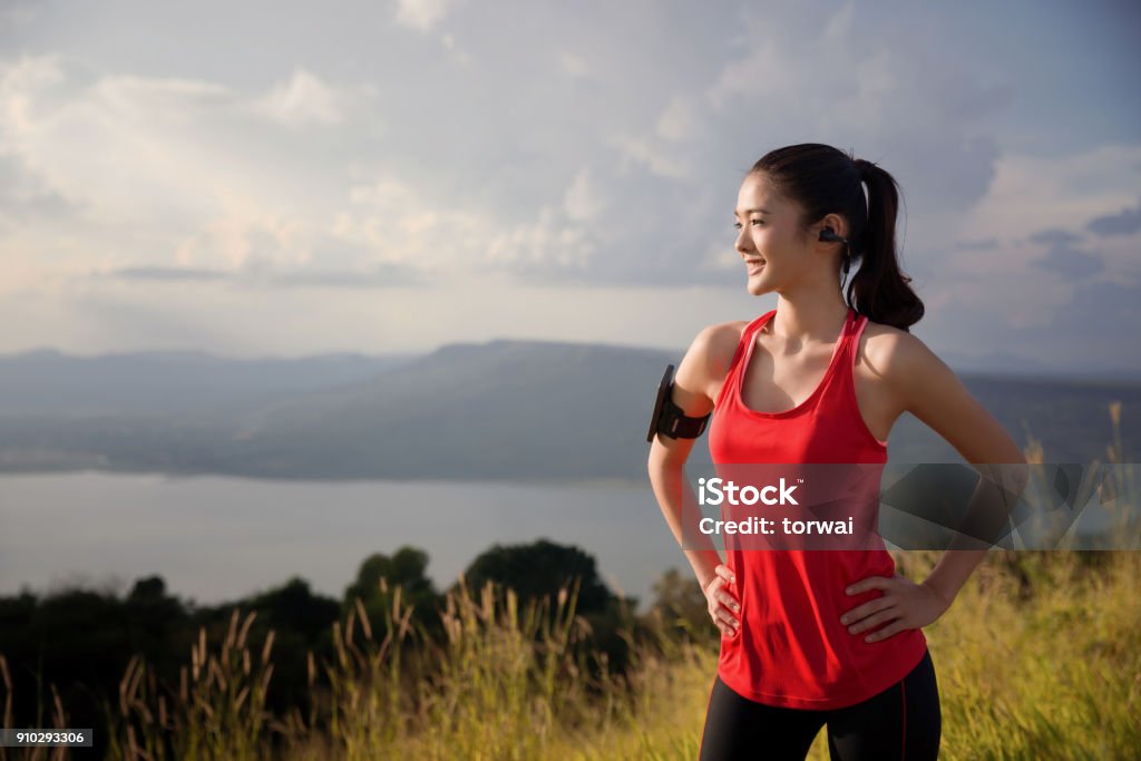 Asian women are relaxing out of the running exercise. She is looking sun Healthy Lifestyle Stock Photo