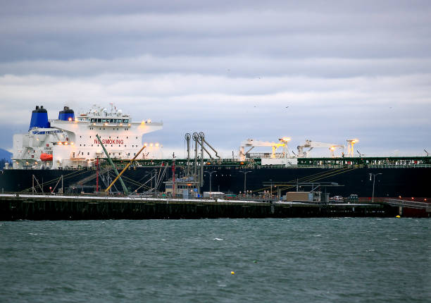 istock Ocean Liner Docked Near Oil Refinery 910300602