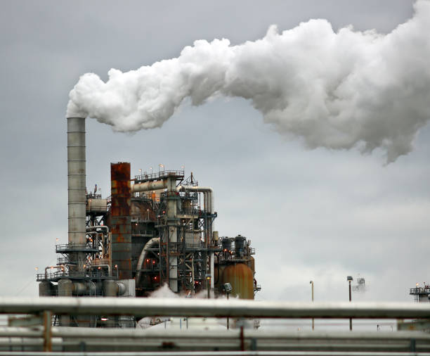 istock Smoke Billows from Oil Refinery Chimneys 910301330