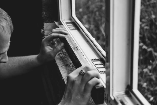 istock worker checks the level of a window 910304174