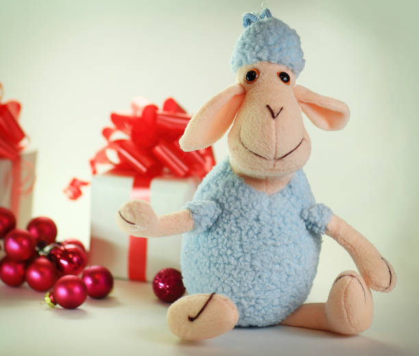istock blue toy sheep and boxes with gifts for Christmas 910307654