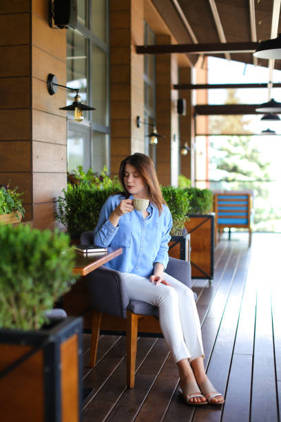 istock Charming girl drinking tea at restaurant 910310898