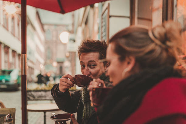 Friends drinking coffee and tea in bar in Germany